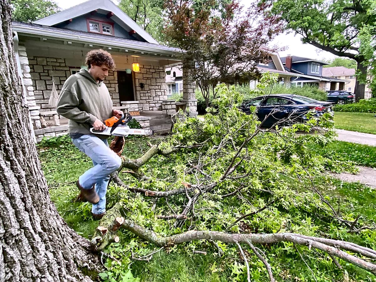 First Class Property Services crew clearing storm debris from a Kansas City metro yard